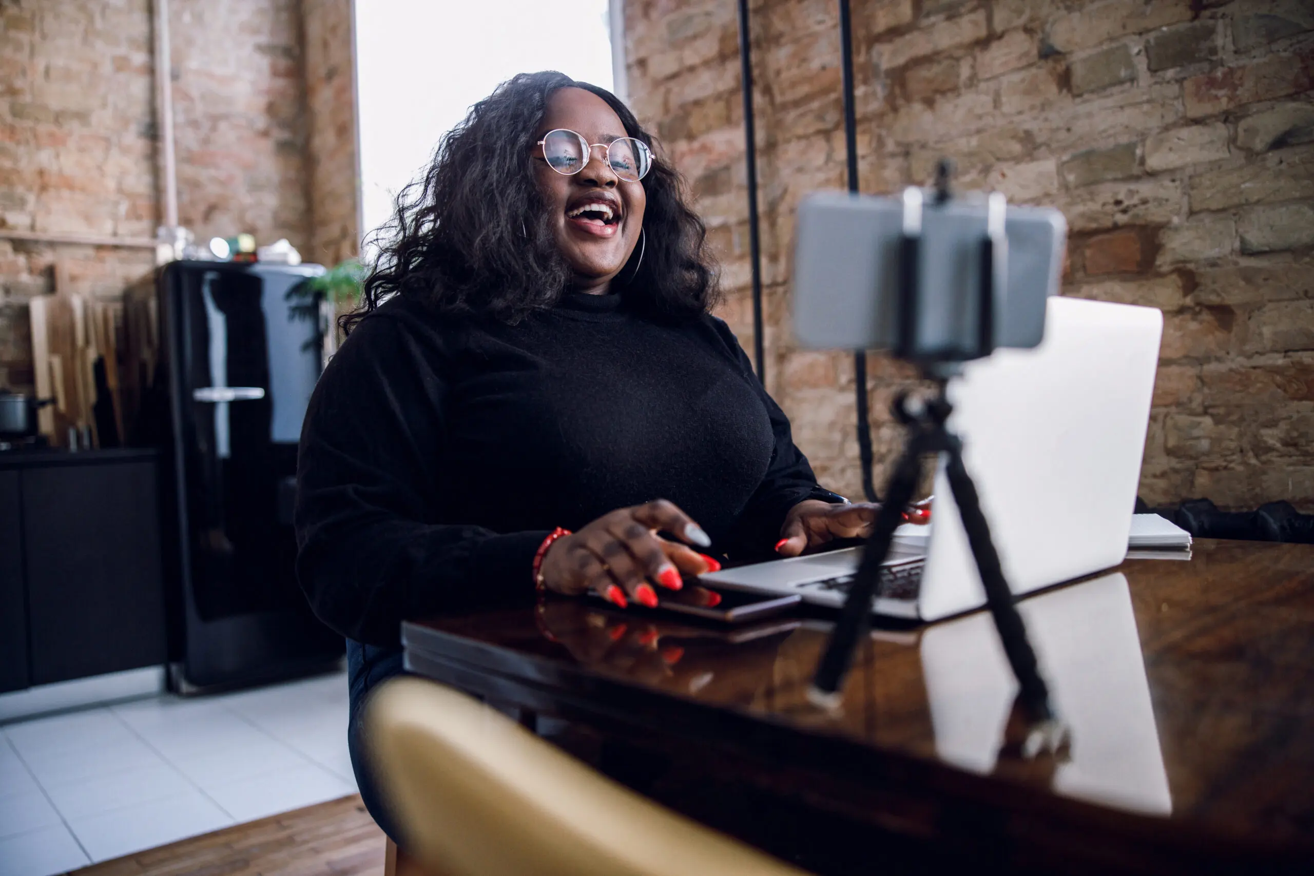 Laughing blogger at home with gadgets stock photo