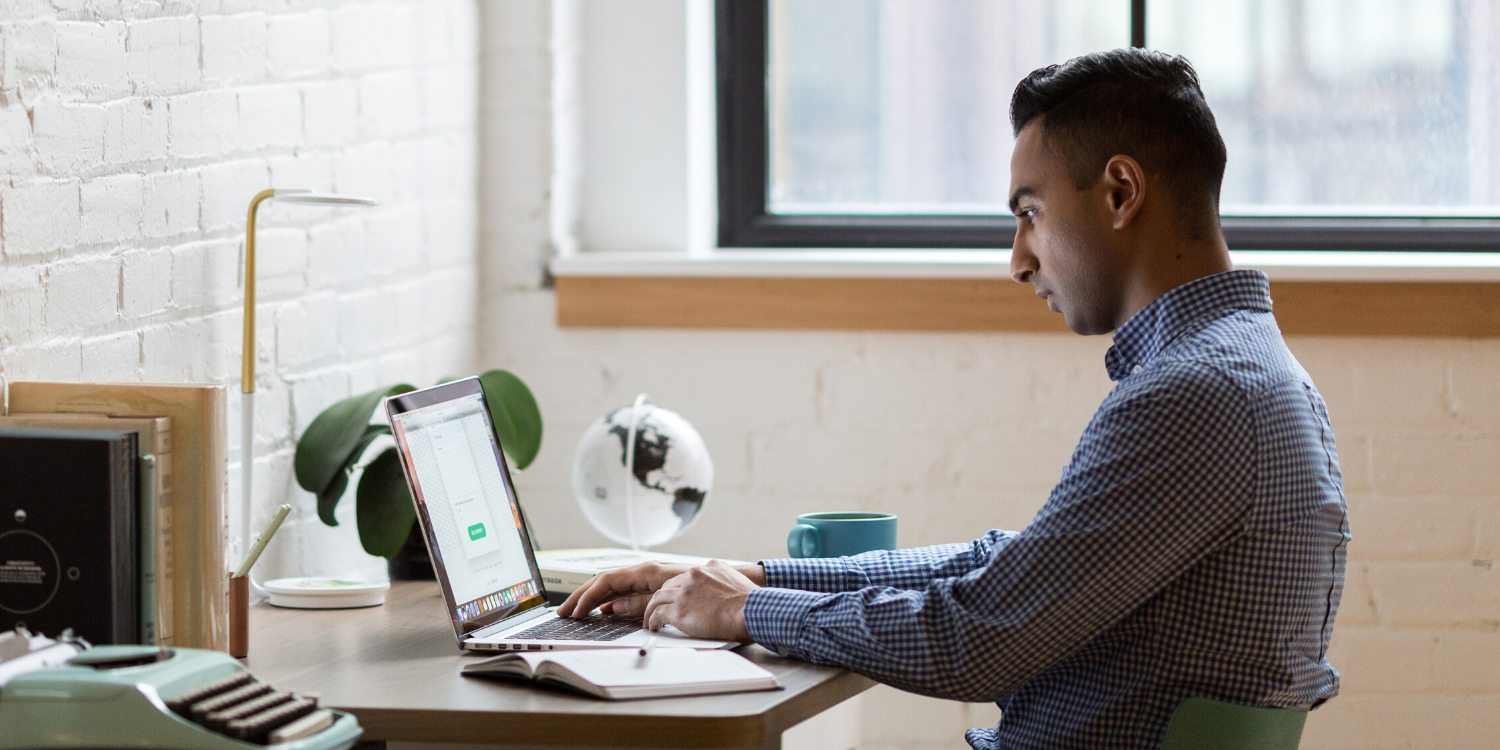 Let’s Talk About It: Embracing Career Ownership in Disruptive Times. An image of a man working on a laptop at his desk.