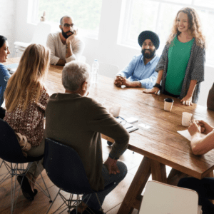 Community members happily talking around a table